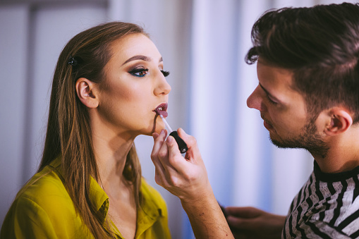 Professinal MakeUp Artist Applying Lip Gloss On JuicyGirl's Lips