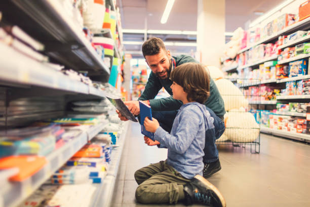istock Father and Son In A Supermarket. 658866818