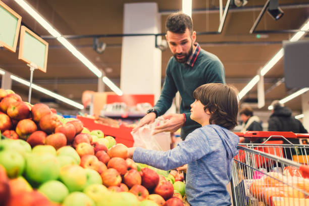 istock Father and Son In A Supermarket. 658867190