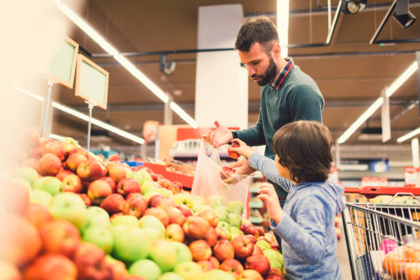 istock Father and Son In A Supermarket. 658867460