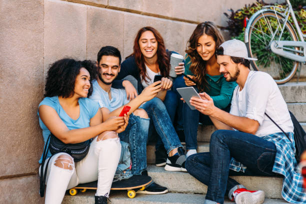 istock Friends browsing the net outdoors 658870134