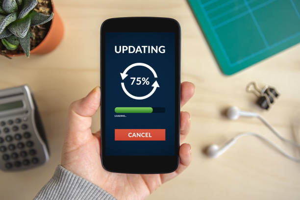 istock Hand holding smart phone with update concept on screen 658870288