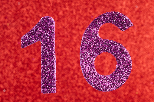 Number sixteen purple color over a red background. Anniversary. Horizontal