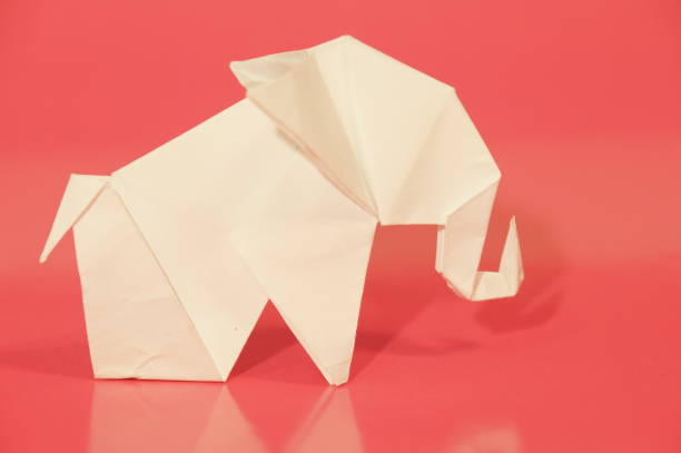 Paper elephant origami is isolated on the background. Elephant made of paper. Japanese culture. Symbol. Wild nature. Paper elephant origami is isolated on the background. Elephant made of paper. Japanese culture. Symbol. Wild nature. бумага stock pictures, royalty-free photos & images