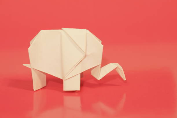 Paper elephant origami is isolated on the background. Elephant made of paper. Japanese culture. Symbol. Wild nature. Paper elephant origami is isolated on the background. Elephant made of paper. Japanese culture. Symbol. Wild nature. бумага stock pictures, royalty-free photos & images