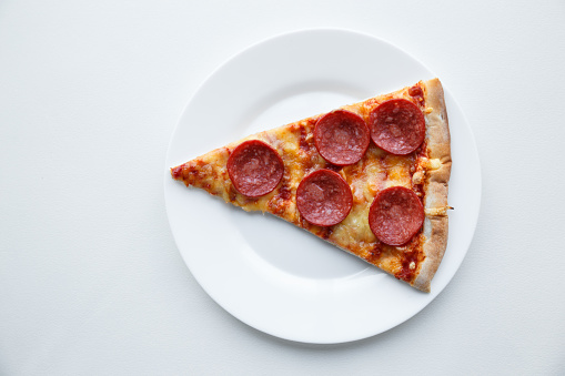 Pepperoni pizza. Hot homemade food. Slice of fresh italian classic salami pizza. Popular topping with cheese. Baked meal.