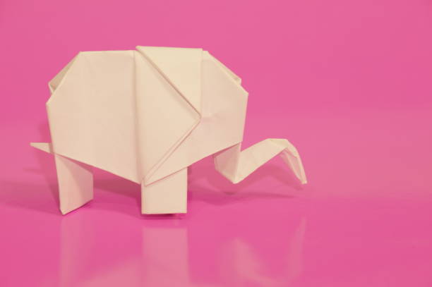 Paper elephant origami is isolated on the background. Elephant made of paper. Japanese culture. Symbol. Wild nature. Paper elephant origami is isolated on the background. Elephant made of paper. Japanese culture. Symbol. Wild nature. бумага stock pictures, royalty-free photos & images