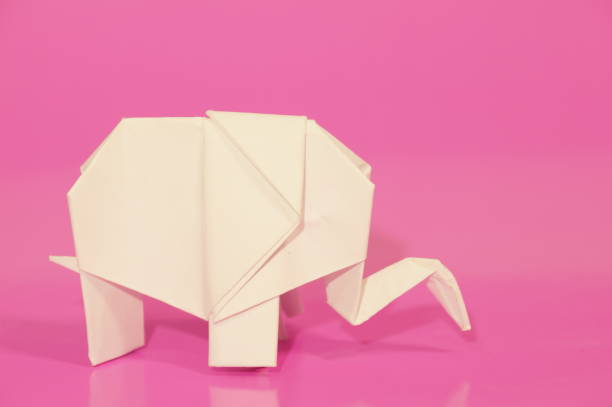 Paper elephant origami is isolated on the background. Elephant made of paper. Japanese culture. Symbol. Wild nature. Paper elephant origami is isolated on the background. Elephant made of paper. Japanese culture. Symbol. Wild nature. бумага stock pictures, royalty-free photos & images