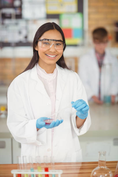 School girl experimenting with chemical in laboratory at school Portrait of school girl experimenting with chemical in laboratory at school science photos stock pictures, royalty-free photos & images