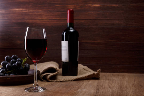 istock Red wine. Wineglass with grapes branch. 658877136
