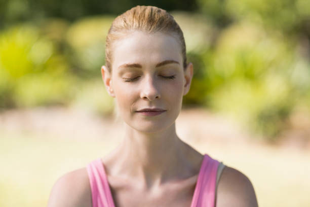 istock Woman meditating in park 658879806