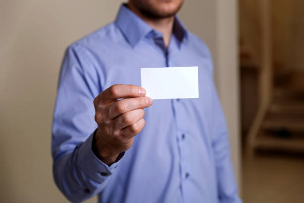 istock Man holding visit or business card. 658880952