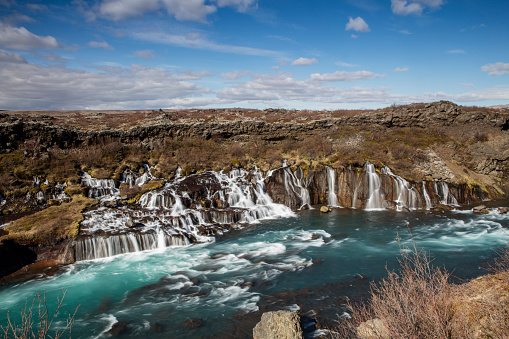 Classic Icelandic landscape with waterfall.