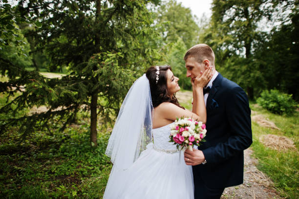 istock Young stylish wedding couple in love at park. 658890782