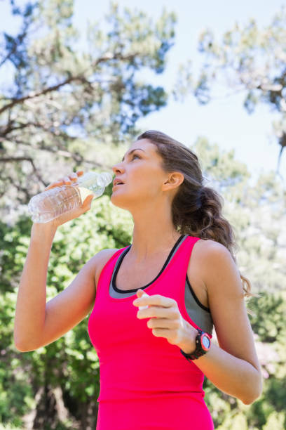 istock Young fit woman drinking water 658894384