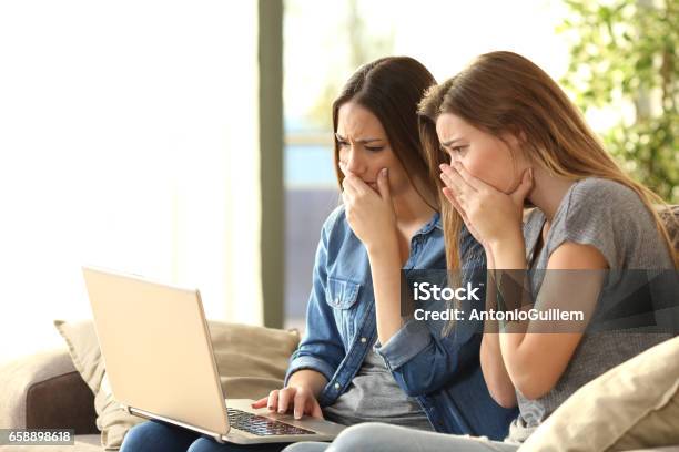 Worried Roommates On Line With A Laptop Stock Photo - Download Image Now - Identity, Mistake, Computer Crime