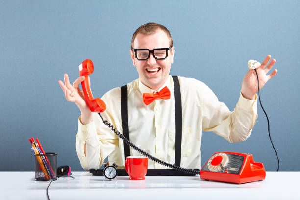 istock Happy nerd guy holding unplugged telephone cable 658901326