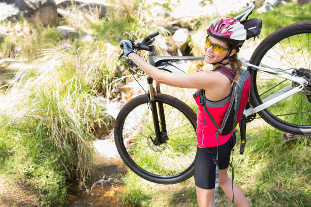 istock Woman carrying her bike 658901334