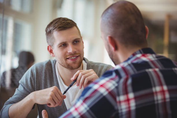 istock Young businessman discussing with colleague in office 658901388