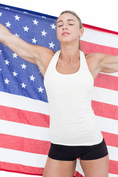 istock Female athlete holding American flag with closed eyes 658901536