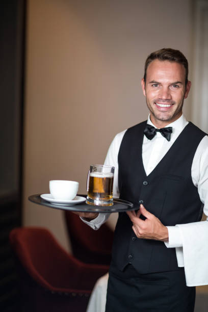 istock Waiter holding tray with beer 658901900