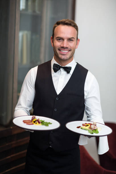 istock Portrait of waiter presenting meals 658902558
