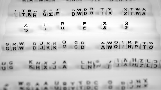 Stress letters between other blurred lettters, black and white.