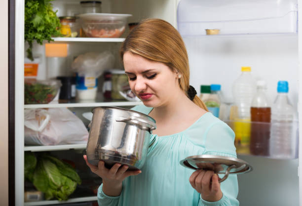woman noticed foul smell of food from casserole upset woman noticed foul smell of food from casserole food poisoning stock pictures, royalty-free photos & images