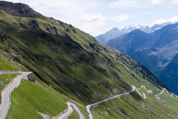 istock Alp road surrounded by blue alp high mountains. 658911298