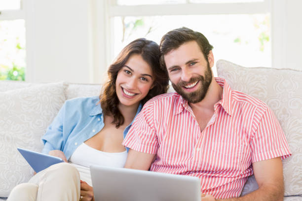 istock Portrait of couple using digital tablet and laptop 658912092