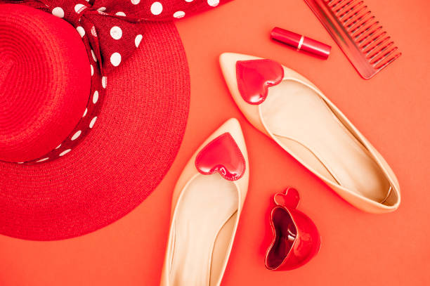 istock Beige And Red Personal Accessory On Orange Background - Directly Above 658913084