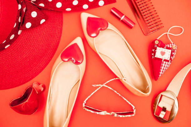 istock Beige And Red Personal Accessory On Orange Background - Directly Above 658913086