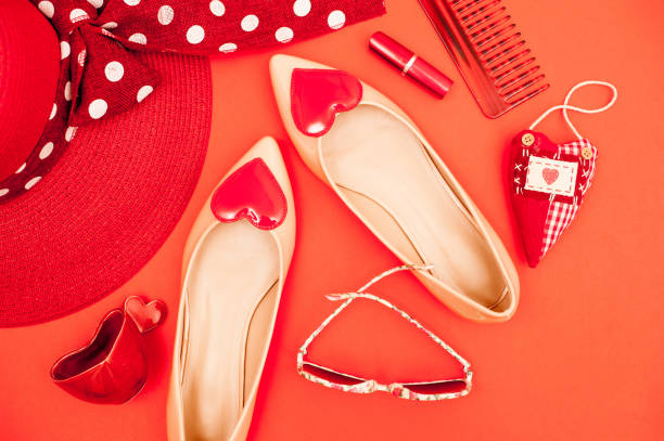 istock Beige And Red Personal Accessory On Orange Background - Directly Above 658913088