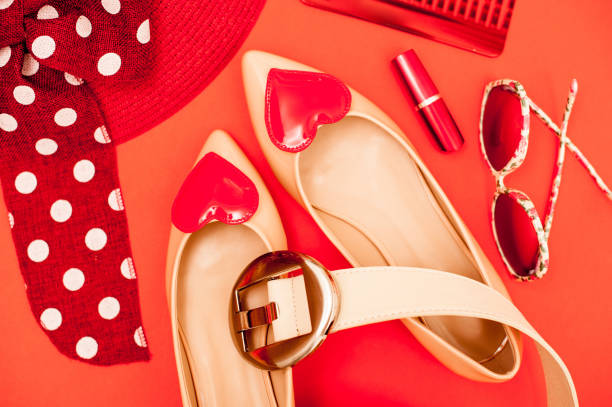 istock Beige And Red Personal Accessory On Orange Background - Directly Above 658913092