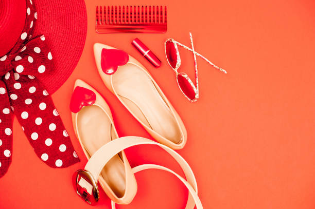 istock Beige And Red Personal Accessory On Orange Background - Directly Above 658913116