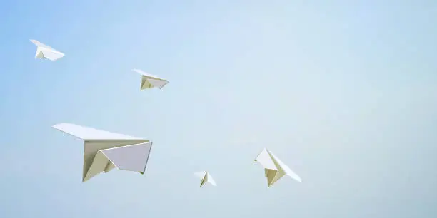 Photo of Paper Airplane Flying Freedom on Sky Background