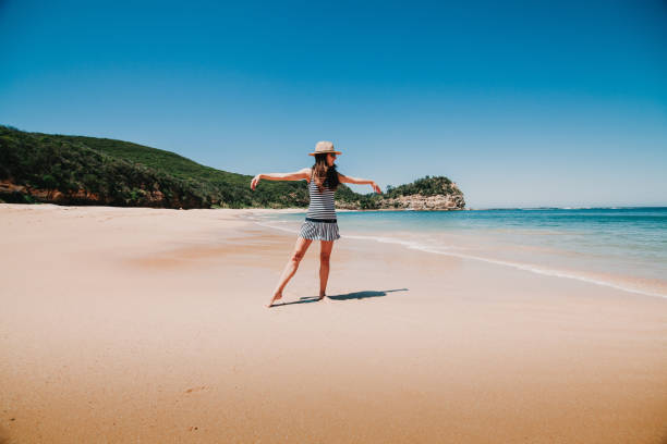 istock Woman dancing and enjoying Australian beach. 658926960