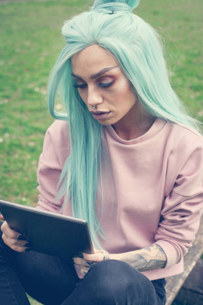 istock Stylish woman using tablet outdoor. 658927450