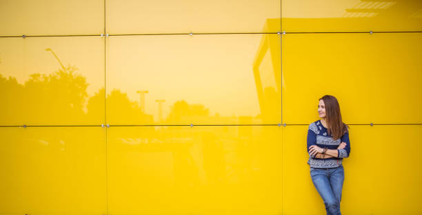 istock Young lady by the yellow wall 658927456