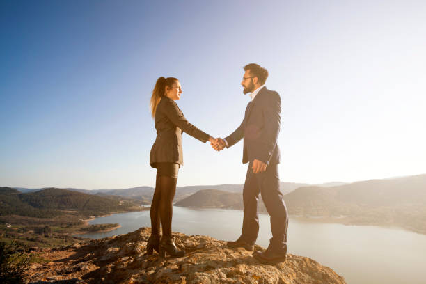 istock Success men and woman on the mountain 658928588
