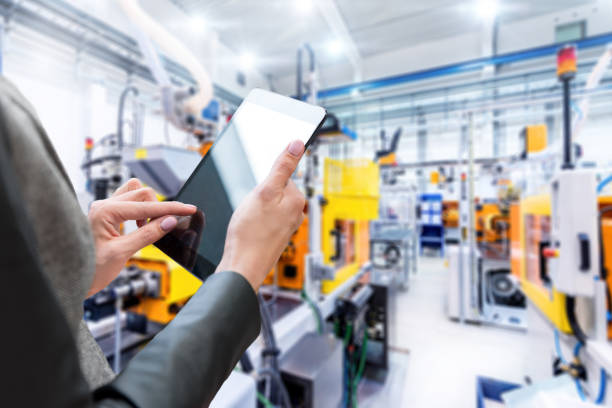 istock Digital tablet & futuristic factory 658929944