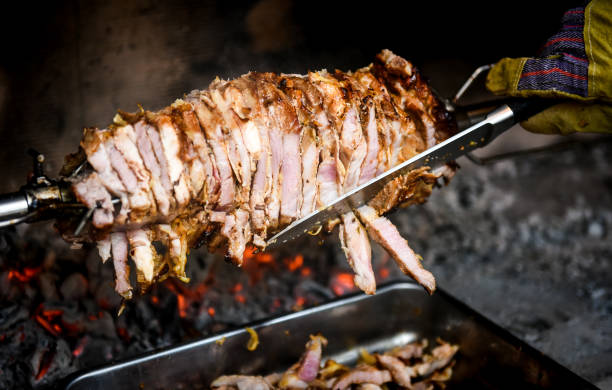 istock Hand cutting home made cag kebab gyros with a knife 658939448