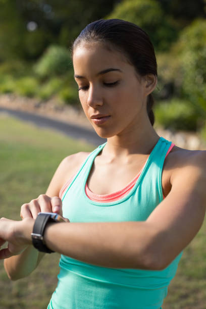 istock Woman adjusting a time on wristwatch 658945782