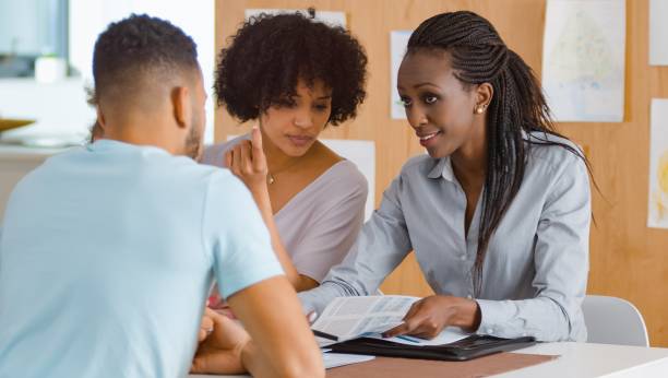 istock Insurance agent talking with couple 658961498