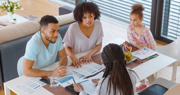 istock Insurance agent talking with couple 658961504