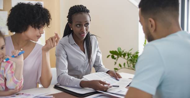 istock Couple discussing with insurance agent 658963688