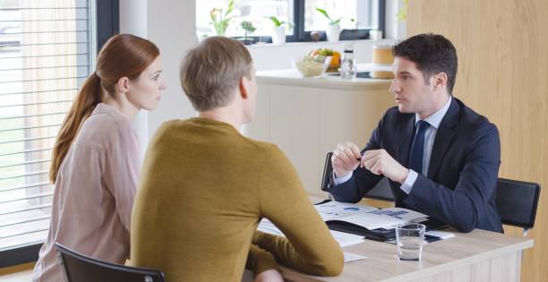 istock Banker discussing with couple 658963724