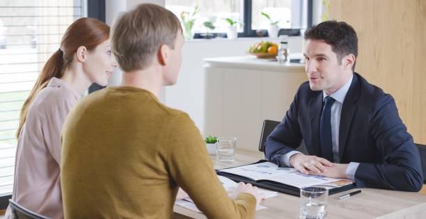 istock Banker discussing with couple 658963728