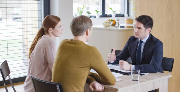 istock Banker discussing with couple 658963734