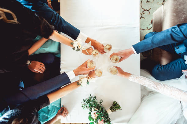istock People hold in hands glasses with white wine. wedding party. 658973792